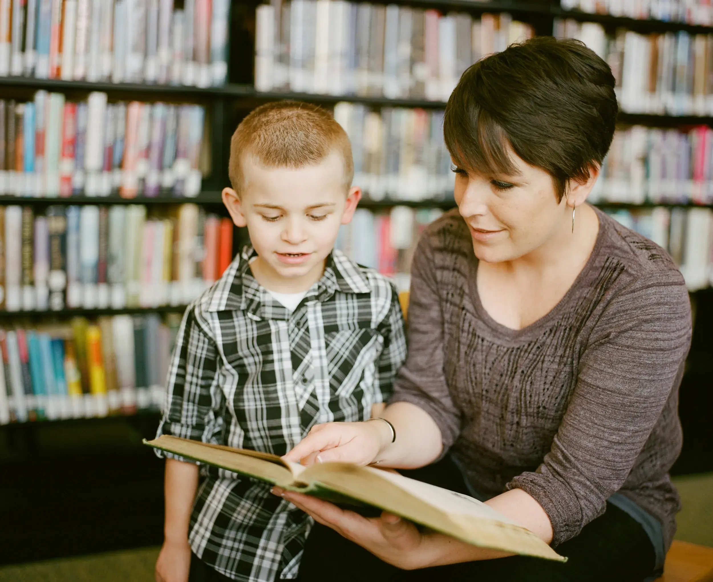 tf-jackson-education-teacher-reads-books-with-student-in-modular-classroom