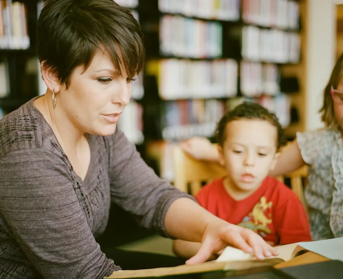 tf-jackson-education-teacher-reads-with-student-in-modular-library-building