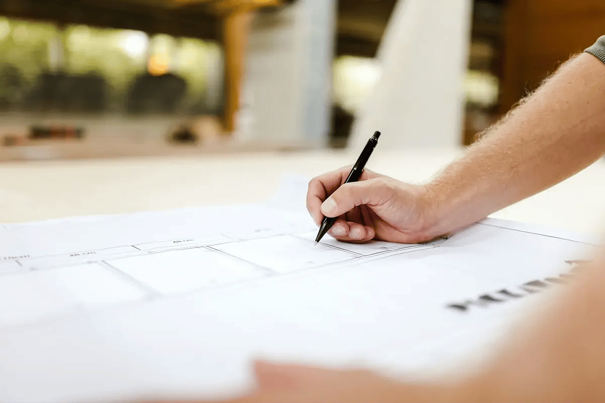 tf-jackson-full-turnkey-solutions-person-makes-notes-on-blueprints