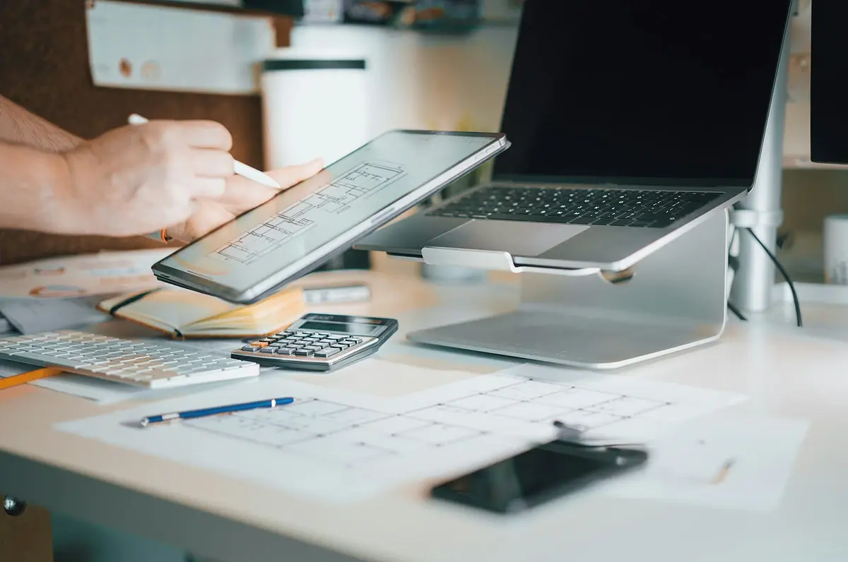 tf-jackson-finance-your-purchase-worker-checks-project-details-on-tablet-at-desk